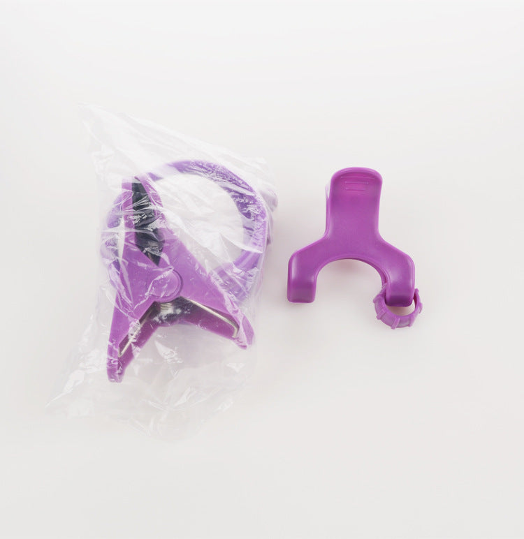 Purple plastic tool with clear plastic cover on a white background
