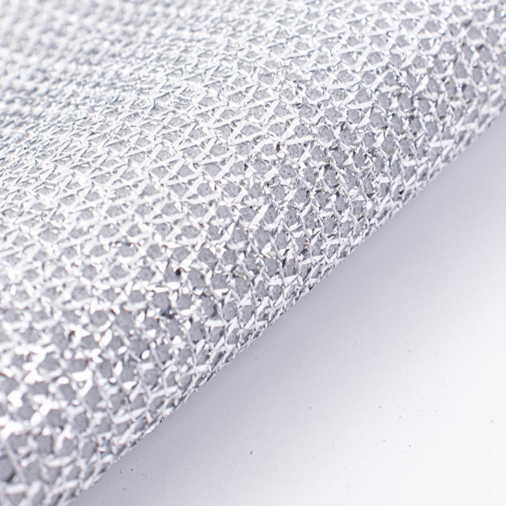 Close-up of a textured, non-scratch Wire Dishcloth on a light gray background