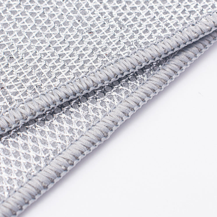Close-up of a textured gray non-scratch wire dishcloth on a white background